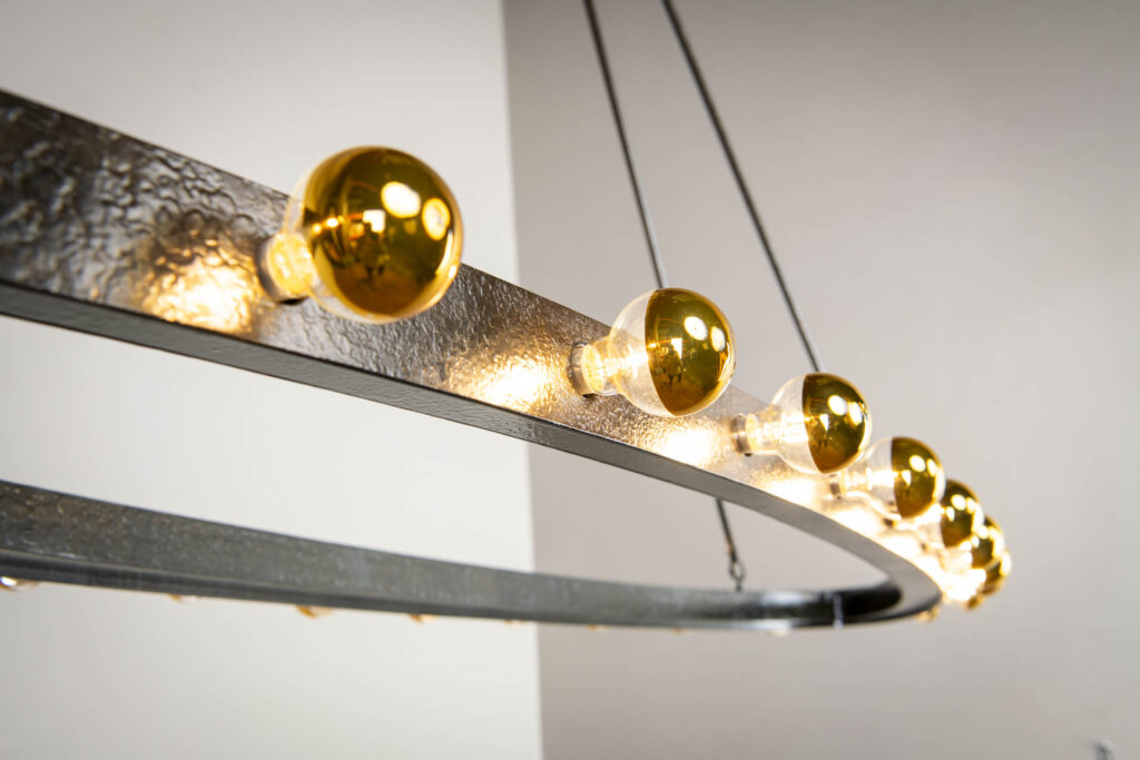 Berriz is an adaptation to the Standish and Winthrop chandelier I designed that are now situated at the Harvard Winthrop House, this chandelier has clean geometric lines textured with a hand-forged firescale finish for a refined and balanced look. https://formandreform.com/standish/